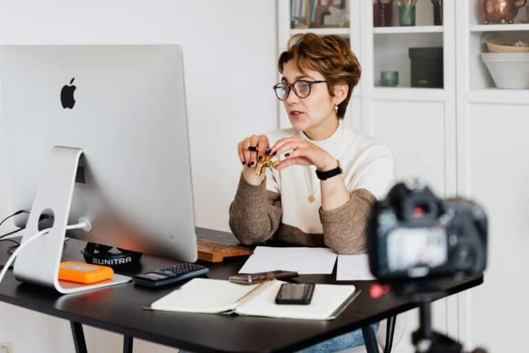Experienced woman explaining tech career coaching costs on a computer call