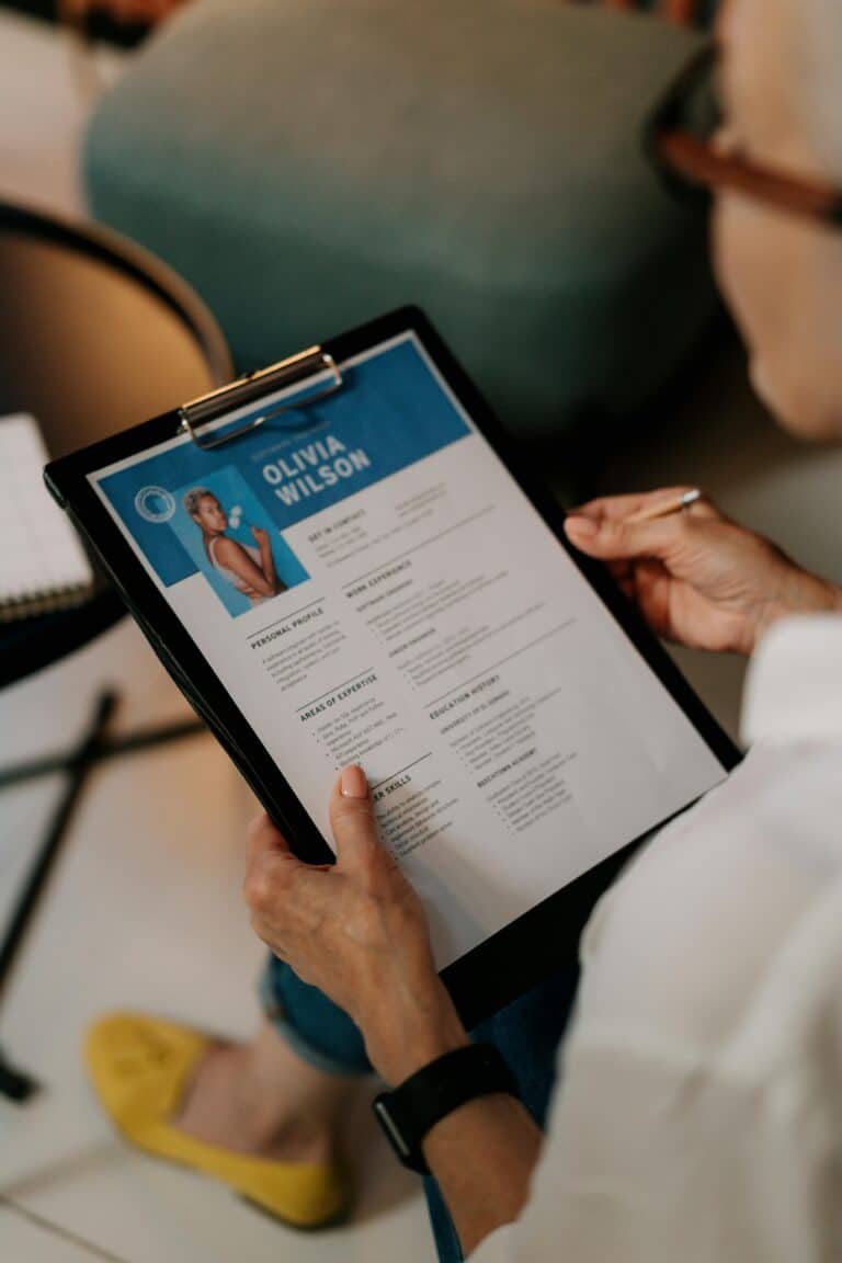 Interviewer holding a candidate’s CV during a tech job interview