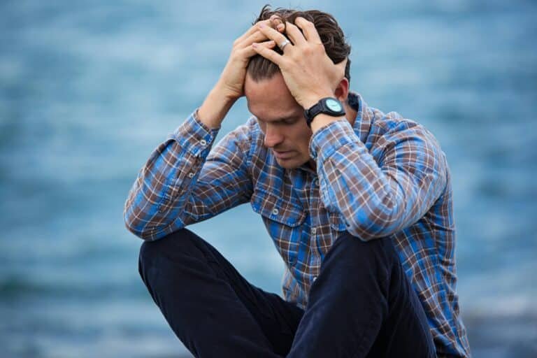 Mid-career tech professional holding head in frustration - symbolizing career challenges
