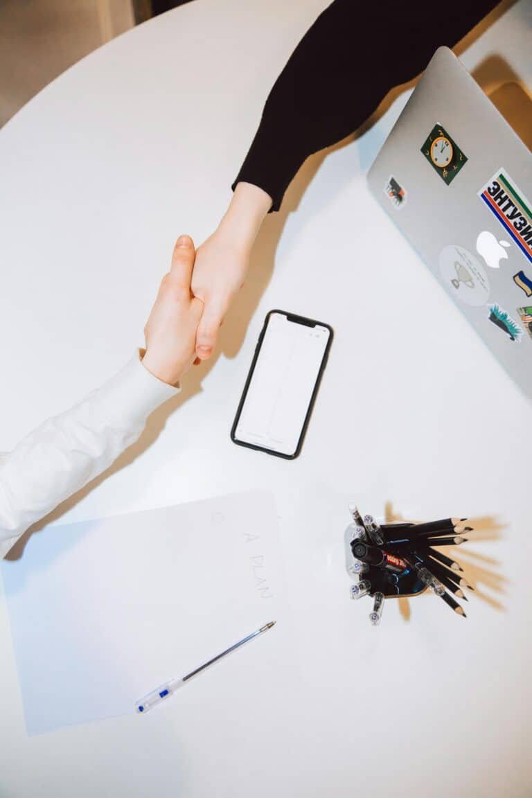Handshake after a job offer – visual metaphor for getting hired via LinkedIn profile optimization